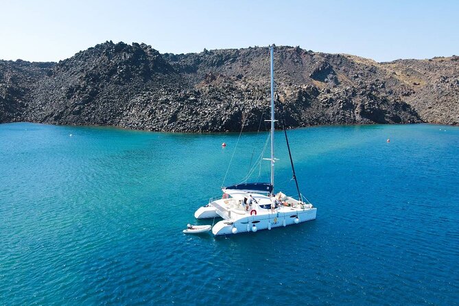 Best of Santorini Private Half-Day Catamaran Cruise with transfer and meal - Red Beach: volcanic color, quick stop, and the best snorkel odds