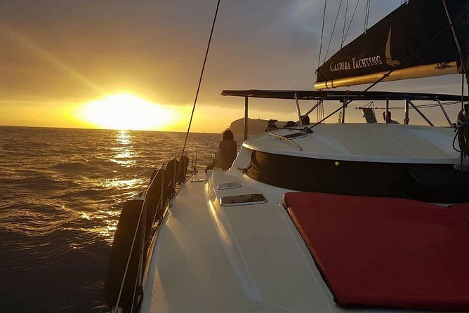 Santorini Adventurous Catamaran Experience with Snorkeling - Food, wine, and the onboard vibe on a vintage-style sailboat