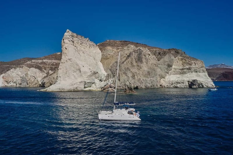 Santorini: Caldera Classic Catamaran Cruise w/ Meal & Drinks - Passing Akrotiri Lighthouse and the Indian Face Mountain
