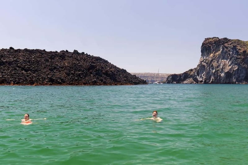 Santorini: Catamaran Cruise with Fresh Meal & Open Bar - Akrotiri Lighthouse: calm sailing with big caldera context