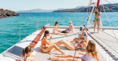 Santorini: Catamaran Tour with BBQ Dinner, Drinks, and Music - Getting on board: pickup timing and how the day starts
