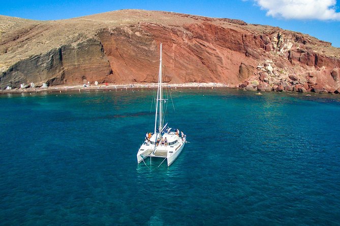 Santorini Half Day Catamaran Private Cruise incl. Meal, Drinks & Free Transport - Vlyhada Port and the Black-Sand Launch Zone