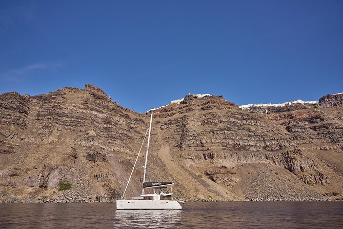Santorini Oia: Luxury Sunset Cruise with Fresh Fish BBQ & Drinks - Nea Kameni islet: lava, sulfur, and high-salt floating