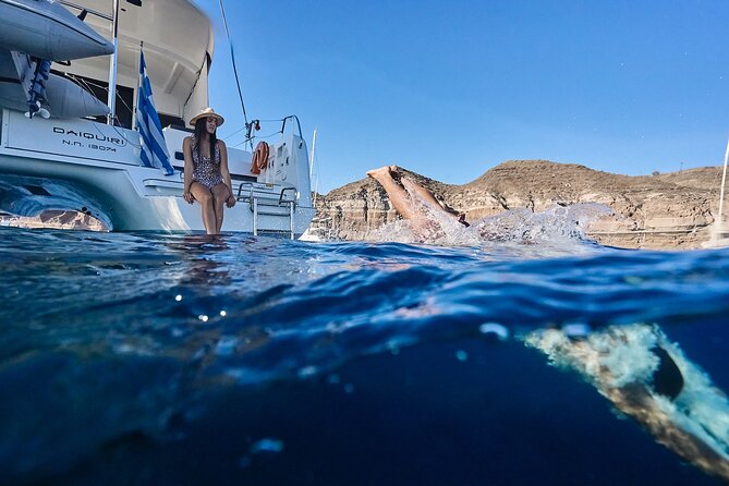 Santorini Oia: Luxury Sunset Cruise with Fresh Fish BBQ & Drinks - Red Beach hour: volcanic colors and your on-board dinner