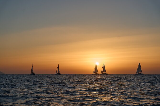 Santorini Oia: Luxury Sunset Cruise with Fresh Fish BBQ & Drinks - The volcano and sulfur springs: black rocks with a therapeutic twist
