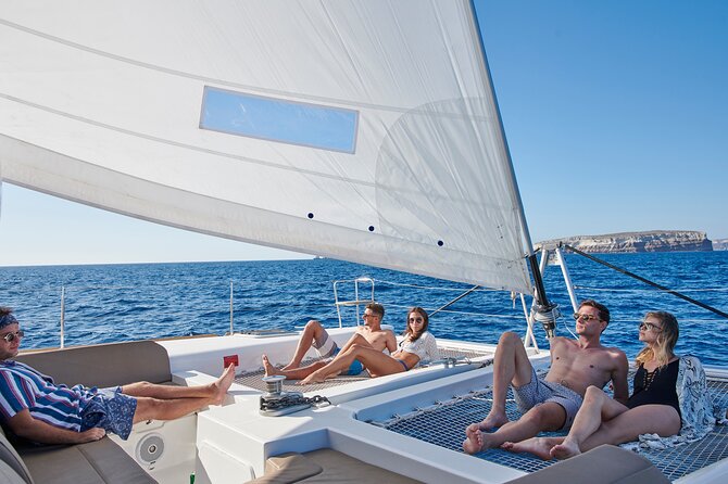 Santorini Platinum Catamaran Cruise with Meal, BBQ and Open Bar - Akrotiri lighthouse photo moment: a 125-year-old landmark from the sea