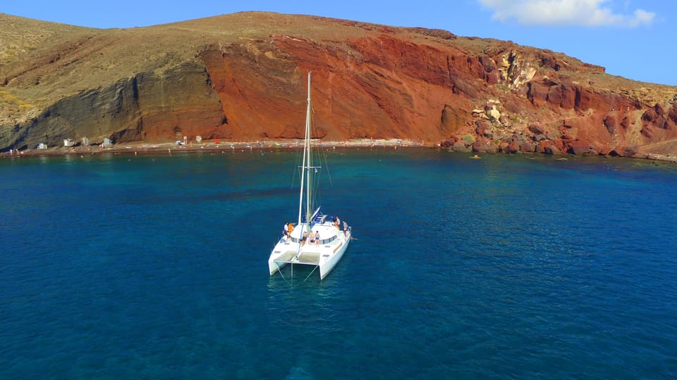 Santorini: Private Catamaran Cruise with Food & Drinks - Akrotiri Lighthouse, Indian Rock, and the boat-level Caldera wow factor