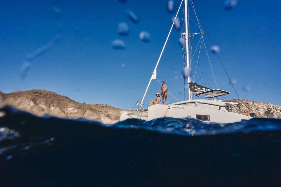 Santorini: Southern Island Luxury Catamaran Cruise with Meal - Red Beach swim-and-snorkel stop: the scarlet-rock payoff
