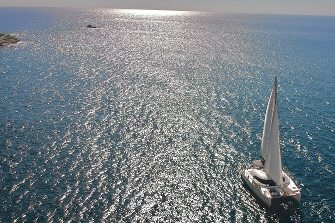 Santorini: Standard Small-Group Catamaran Cruise with Food/Drinks - Red Beach swim time: dramatic cliffs, limited help