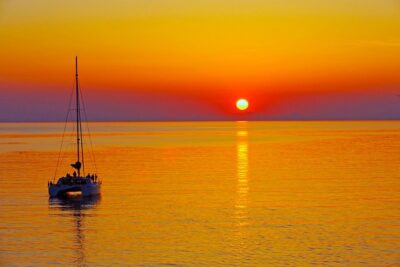 Santorini Sunset Luxury Sailing Catamaran Cruise with BBQ, drinks, transfer - Red Beach snorkeling stop: swim time with dramatic color cliffs