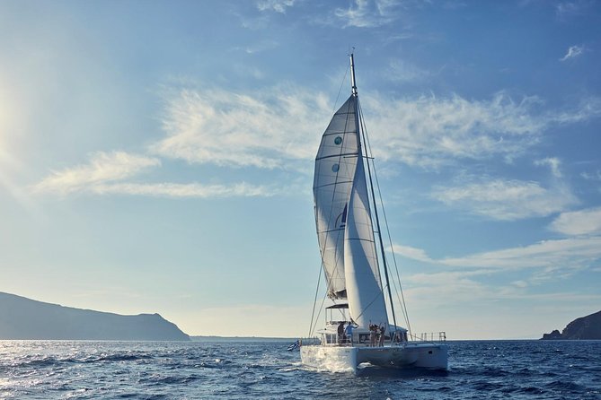 Santorini Sunset Luxury Sailing Catamaran Cruise with BBQ, drinks, transfer - Onboard vibe: music, restrooms, towels, and what you actually get