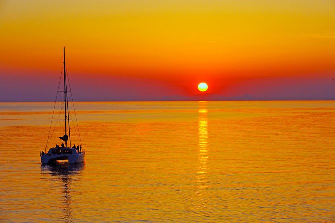 Santorini Sunset Luxury Sailing Catamaran Cruise with BBQ, drinks, transfer - Red Beach snorkeling stop: swim time with dramatic color cliffs