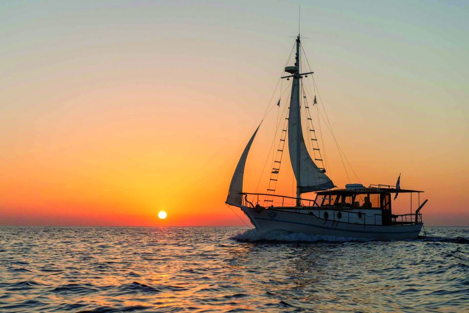 Santorini: Traditional Wooden Boat Tour with Meal and Wine - Black Mountain swimming and snorkeling: the clearest water moment