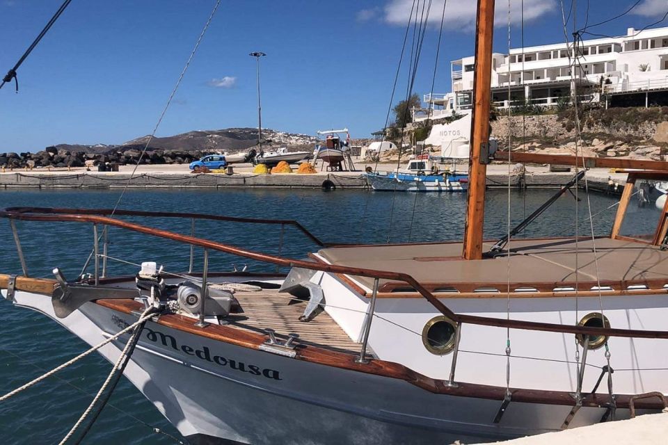 Santorini: Traditional Wooden Boat Tour with Meal and Wine - Volcanic hot springs: geothermal swimming that feels like a trick